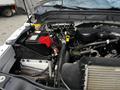 Engine compartment of a 2016 Ford F-550 showing the battery hoses and various engine components