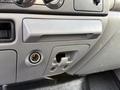 Interior dashboard of a 2006 Ford F-550 featuring control knobs a storage compartment and an automatic gear shift slot
