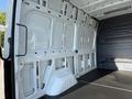 Interior view of a 2020 Mercedes-Benz Sprinter showing the empty cargo area with white paneling and a flat black floor