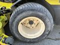 A wheel from a 2010 Kubota F3990 featuring a yellow rim and a black tire with visible treads and bolts