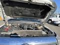 A 2014 Ford F-350 SD with the hood raised revealing the engine bay and various engine components visible