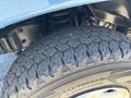 Close-up of a 2008 Ford E-350 tire showcasing detailed tread patterns and the vehicle's suspension system components