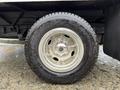 Close-up of a shiny chrome wheel on a black tire belonging to a 2013 Ford Econoline