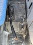 Close-up of the control lever and various controls on the floor of a 2010 New Holland T4050 tractor's cabin