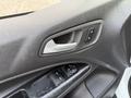 Close-up of the door panel of a 2017 Ford Transit Connect showing the handle and window controls