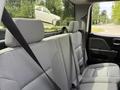 Interior view of a 2018 Chevrolet Silverado 1500 showing the back seat with seat belts in place and a gray fabric upholstery