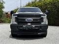Front view of a 2017 Ford F-250 Super Duty with a black grille and bumper visible showcasing the Ford logo and a mounted winch
