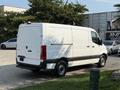 A 2021 Mercedes-Benz Sprinter van in white parked with a plain rear view and black accents