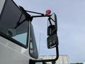 A close-up of the exterior mirror and warning light of a 2016 International 7600 truck