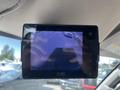 A monitor displaying a rearview camera feed from a 2016 Chevrolet Express showing the view behind the vehicle
