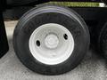 A large Goodyear tire mounted on a white wheel with a multi-stud pattern designed for a 2011 International 4400 truck