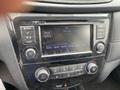 Dashboard controls of a 2019 Nissan Rogue featuring a radio display with various buttons and knobs for audio and climate settings