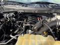 The engine compartment of a 2021 Ford F-150 showcasing the engine components and surrounding systems