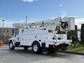 A white 2011 International 4300 bucket truck with an elevated boom and platform for aerial work