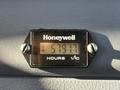 A Honeywell hour meter displaying 5791 hours on a black panel with two screws securing it