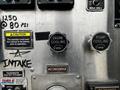 Close-up of control panel with knobs labeled Engine Cooling and Pump Cooling both in open position alongside caution sign and markings indicating pressure and intake information