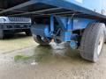 A blue 2011 Freightliner Cascadia Nordic truck with visible wheels and undercarriage components including an air tank and suspension system