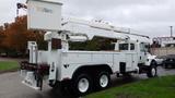 A white 2005 International 7400 truck with an Altec aerial lift mounted on the back and a utility bed for storage