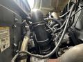 Close-up view of the engine components of a 2008 International 7500 showing various hoses and pipes connected to the engine block and turbocharger