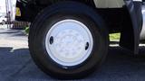 Close-up of the wheel of a 2015 International 7400 featuring a white rim and a large black tire