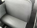 A gray vinyl seat in the interior of a 2007 Freightliner B2 bus with a smooth texture and curved backrest