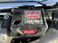 A Warn winch control box with a frost-covered surface positioned on the engine compartment of a 2017 Chevrolet Silverado 3500HD