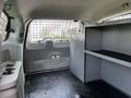 A 2011 Dodge Grand Caravan interior showing a spacious cargo area with a metal partition and built-in shelves