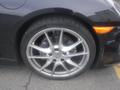 A close-up of a silver alloy wheel on a 2016 Porsche Boxster featuring a black tire with visible brake calipers and disk brakes