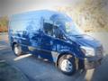 A blue 2017 Mercedes-Benz Sprinter van with a high roof and large cargo area parked on a flat surface