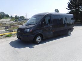 2017 Ford Transit van with a black exterior parked on a roadway