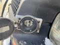 Close-up of the fuel filler cap on a 2005 Chevrolet Express showing the nozzle receptacle inside the cap