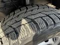 Close-up of a tire on a 2018 Ford Transit showcasing a detailed tread pattern and worn rubber indicating usage