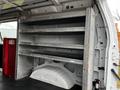 A 2011 Ford Econoline with open shelving compartments in a spacious cargo area