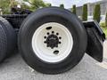 Close-up of a 2012 Volvo VNL truck tire showcasing a large black tire with a white rim and central hub displayed prominently