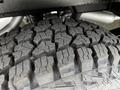 Close-up of a rugged tire tread on a 2022 Ford Transit showcasing deep grooves and intricate patterns designed for traction and durability