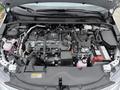 A 2025 Toyota Corolla engine bay displaying the engine and various components such as hoses and the battery