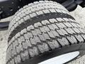 Close-up of a treaded tire from a 2017 Isuzu NPR HD showing deep grooves and a rugged surface designed for traction and durability