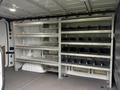 A 2017 Mercedes-Benz Sprinter van with organized shelving and black storage bins inside the cargo area