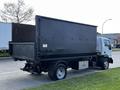 A 2009 Ford LCF 550 truck with a large black box bed and a silver fuel tank attached to the chassis