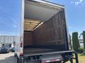 A 2015 Freightliner M2 106 truck with an empty cargo area showing wooden walls and a metal frame