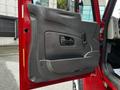 The image shows the interior door panel of a 2011 International 4400 featuring a smooth gray surface with a handle and a latch mechanism