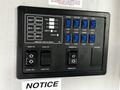 Control panel for a 2022 Heartland Torque featuring button controls for lights slide outs awning and various tank levels
