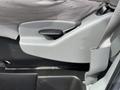 Close-up of the adjustable seat lever on the side of a 2009 Ford Econoline with gray fabric and plastic components