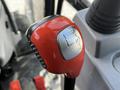 Close-up of the gear shifter for a 2018 New Holland Boomer 45 featuring red plastic grip and metal numbers indicating 1 2 N 3