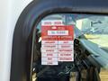 A 2017 Chevrolet Express displaying a red and white certificate of approval with months listed and dates marked.