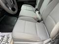 Front seats of a 2016 GMC Sierra 1500 with a gray fabric upholstery and seat belts visible