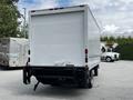 A white 2018 Hino 195 truck with a boxy cargo area facing away from the viewer showing a simple design and no visible markings or branding