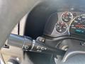 Close-up of the turn signal and wiper controls on the steering column of a 2020 Chevrolet Express with instrument cluster visible in the background