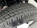 Close-up of a treaded tire from a 2021 Ford E-450 showing detailed grooves and patterns designed for traction