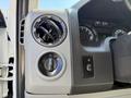 Interior dashboard controls of a 2013 Ford Econoline featuring air vents a headlight switch and power window controls
